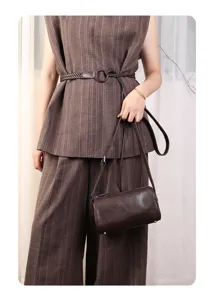 Minimalist brown genuine leather barrel bag, stylish mini crossbody handbag for daily commute.