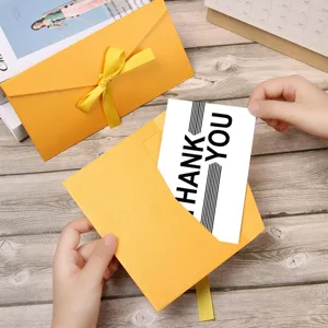 Yellow envelope set with ribbon and thank you card for gift decoration and greeting.