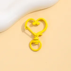 Yellow heart-shaped lobster clasp keychain DIY handmade jewelry accessory metal hook detail.