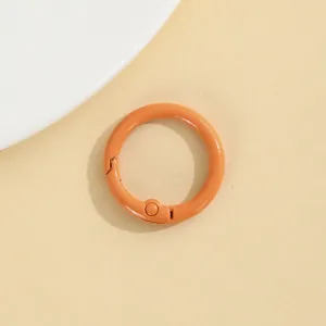 Close-up detail van de oranje zinklegering veer ronde snaphaak accessoire voor sleutelhangers.