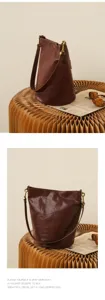Detailed view of a premium brown leather bucket bag showing elegant craftsmanship and texture.