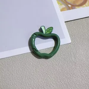 Close-up detail of a cute green apple-shaped spring ring keychain clasp, DIY accessory.