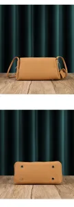 Detailed view of the soft leather pleated crossbody bag, showing texture and metal feet.