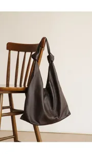 Brown leather hobo shoulder bag for women, elegant knot handle commuter handbag daily fashion tote.
