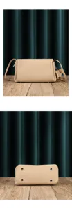 Close-up detail view of soft cowhide pleated shoulder crossbody bag with metal feet.
