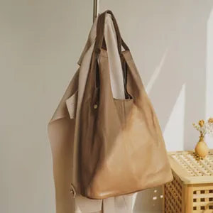 Minimalist genuine leather shoulder bag for women, large capacity commuter dumpling bag.