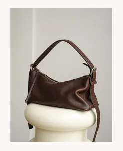 Detailed view of the vintage brown leather hobo shoulder bag, showing premium texture and hardware.