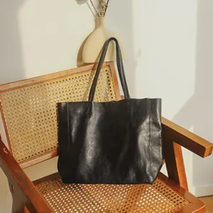 Stylish black genuine leather tote bag for women, large capacity casual shoulder bag.