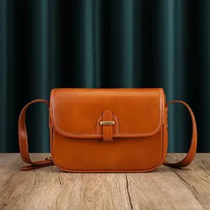 Vintage brown leather shoulder bag for women, classic crossbody design with metal lock.