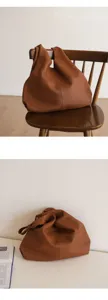 Detailed view of the brown genuine leather slouchy tote bag showcasing soft texture and design.