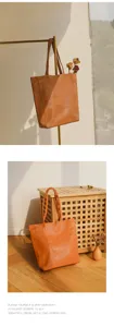 Classic brown leather tote bag detail view, minimalist large capacity shoulder bag for daily commute.