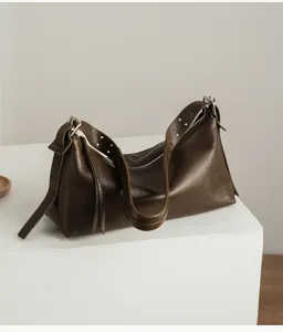 Vintage genuine leather hobo shoulder bag, premium pillow bag detail shot showing texture.