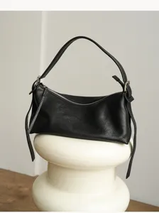 Leather hobo shoulder bag detail, vintage black pillow purse showing fine texture and sleek strap.