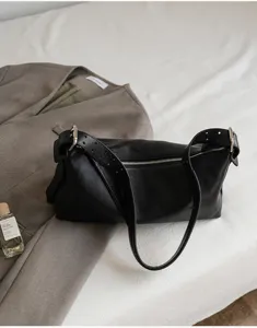 Black genuine leather hobo shoulder bag, vintage pillow bag detail showcasing soft leather and sleek zipper.
