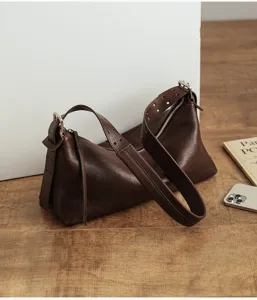 Retro brown leather hobo shoulder bag, vintage pillow purse with wide strap and zip closure.