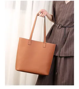Detail view of brown genuine leather tote bag, large capacity underarm shoulder bag.