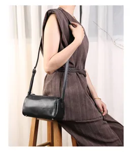 Black genuine leather barrel bag mini crossbody casual shoulder bag detailed product view.