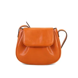 Orange leather saddle bag for women, stylish cross-body shoulder purse with flap closure.
