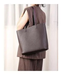 Detail view of the elegant brown leather tote bag showcasing premium texture and spacious design.