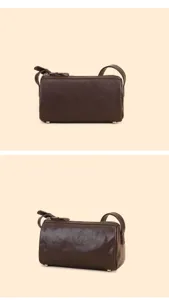 Detailed view of the dark brown leather barrel bag, showing premium texture and neat stitching.