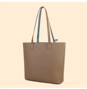 Genuine leather tote bag detail shot, double-sided contrast color, large capacity design.