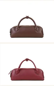 Minimalist leather boston bag, elegant cylindrical handbag and shoulder purse for daily commute.