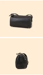 Black genuine leather cylindrical pillow bag detail shot showcasing fine stitching and hardware.