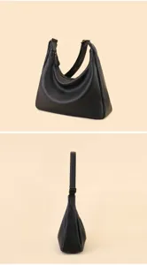 Detailed view of black leather hobo shoulder bag featuring metal zipper and adjustable strap.