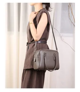 Leather boston bag shoulder side view detail showing smooth texture and premium hardware construction.