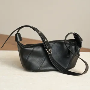 Minimalist black leather croissant shoulder bag for women, chic everyday crossbody purse