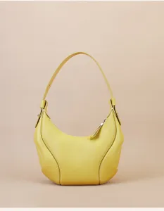 Detailed view of yellow leather crescent hobo bag, fine stitching texture, sleek curved design.