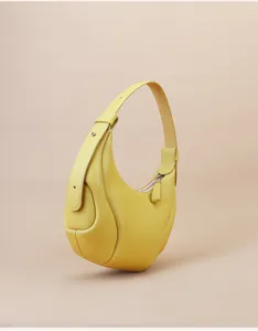 Yellow cowhide crescent underarm bag detail, premium leather shoulder bag craftsmanship.