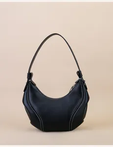 Detailed view of black genuine leather underarm hobo bag, stylish crescent moon shoulder bag.