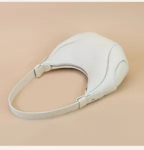 Detailed view of the premium leather crescent hobo shoulder bag in off-white finish.