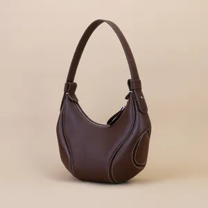 Brown leather shoulder bag for women, stylish hobo crescent bag with contrast stitching for daily commute.