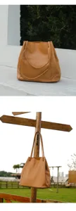 Detail view of brown leather tote bag, soft cowhide large capacity commuter shoulder bag.
