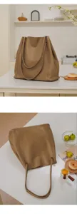 Detail view of large capacity vintage soft leather tote bag, minimalist style commuter handbag.