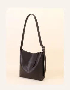 Minimalist dark brown leather shoulder bag, soft bucket design for women daily work commute.