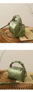 Detailed view of a vintage green Chinese style printed pillow shoulder bag with chic handle.