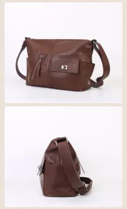 Detail view of the brown leather shoulder bag, highlighting front pocket and side profile.