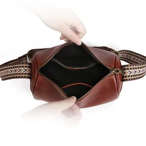 Stylish women brown leather barrel crossbody bag with ethnic wide strap for casual daily use.