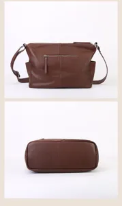 Brown leather shoulder bag detail showing back zipper pocket and flat bottom construction.