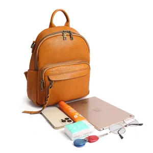 Vintage genuine leather backpack for women, large capacity travel school bag in solid tan color.