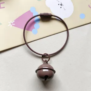 Brown metal bell keychain with wire loop, cute bag pendant and keyring charm for gifts.