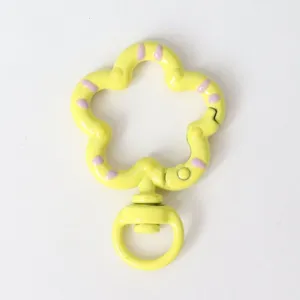 Detailed close-up of a cute yellow flower shaped swivel snap hook keychain DIY accessory.