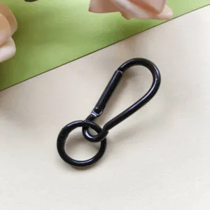 Close-up detail of black metal spring ring and snap hook, ideal for DIY craft charms.