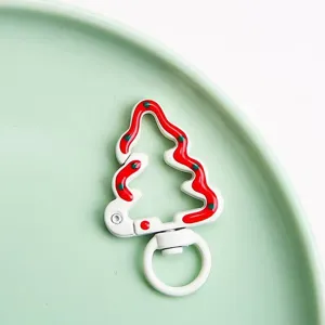 Christmas tree spring clasp detail, metal enamel DIY jewelry accessory and bag pendant closeup.