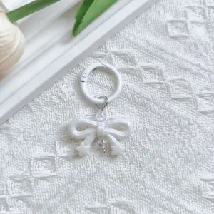White UV electroplated bow keychain detail, cute bag charm pendant with metal spring ring.