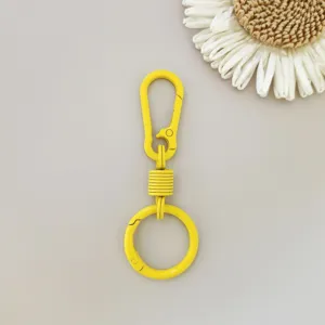 Yellow zinc alloy spring keyring carabiner hook, detailed view of the metal snap ring.