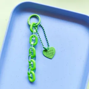 Detailed view of the jelly green acrylic chain keychain and lovely heart pendant for bags.